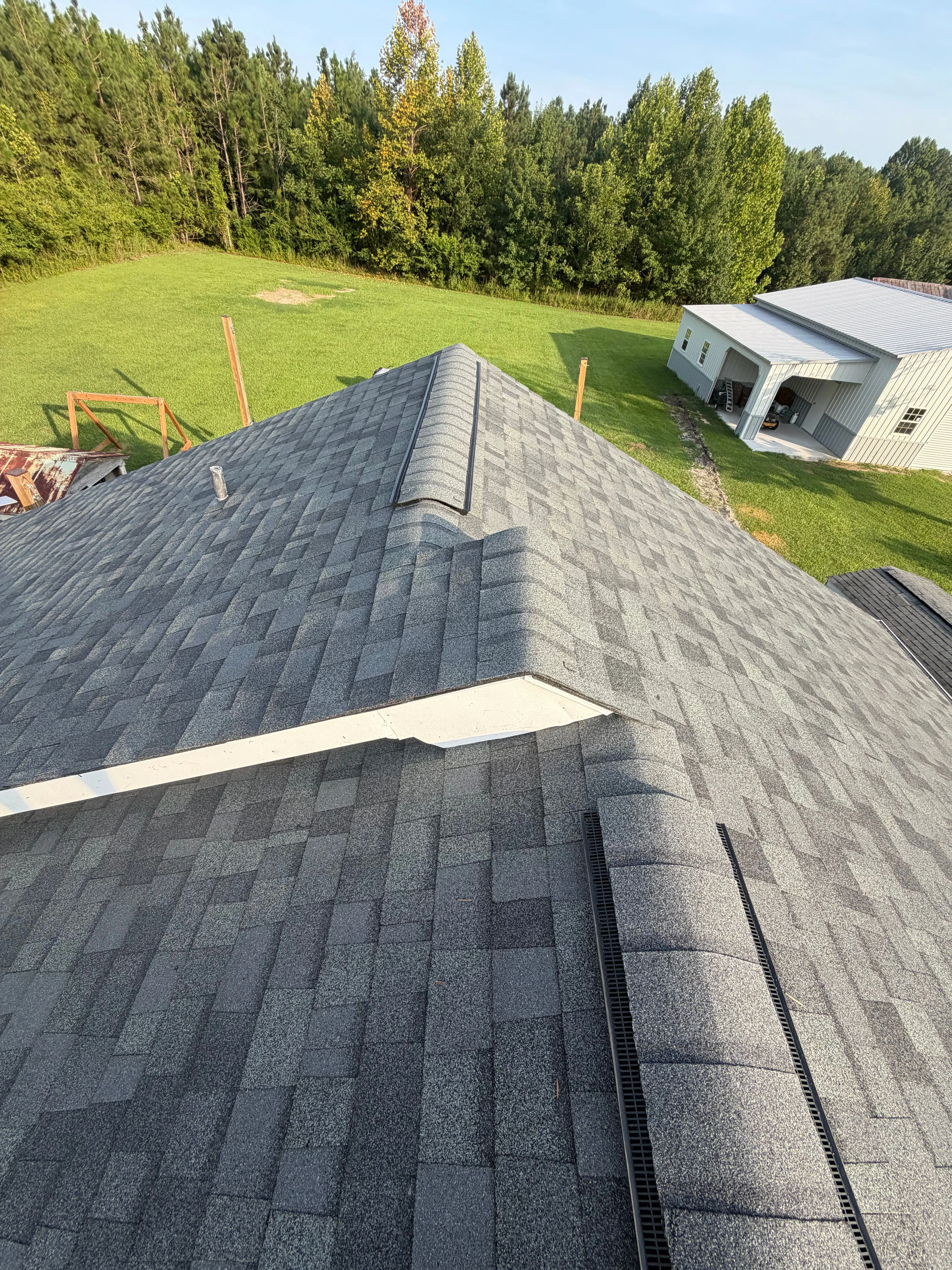 Professional roofer installing shingles on a residential roof