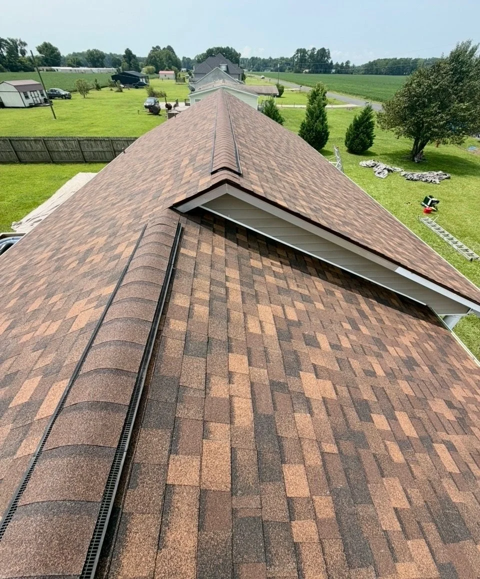 Roofer performing maintenance on a residential roof